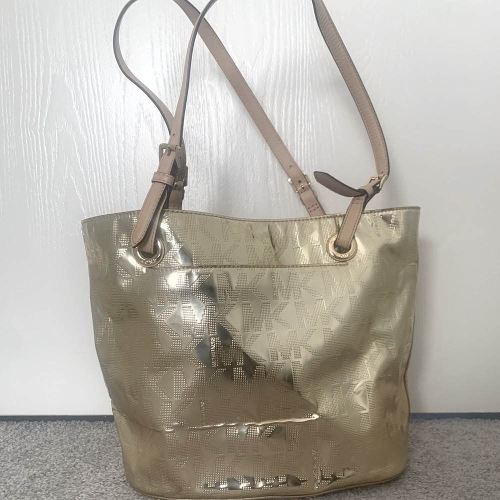 Michael Kors gold metallic purse. Never used. Pristine condition.